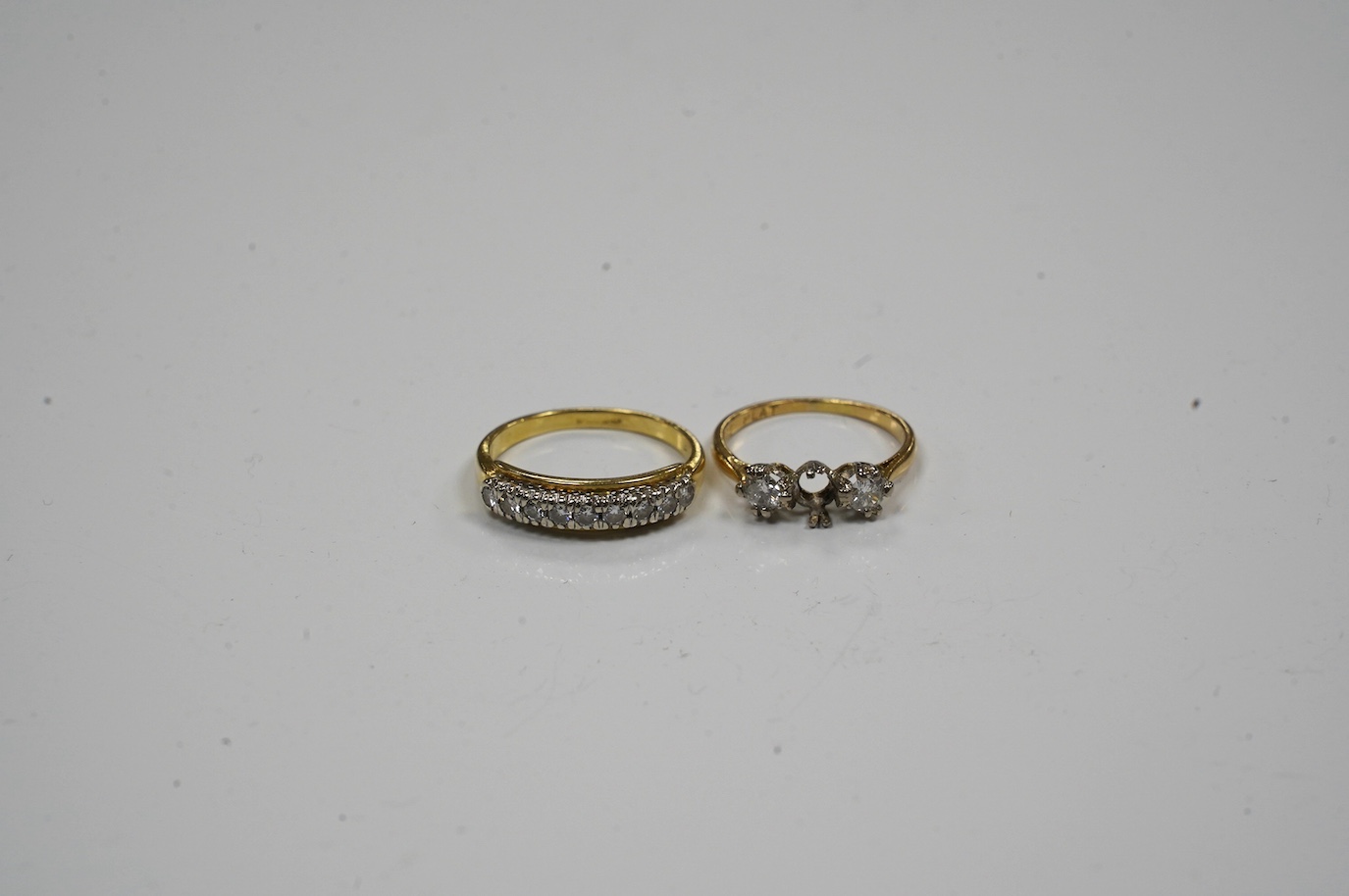 An 18k and diamond chip set half hoop ring, size N and an 18ct, plat, and three stone diamond ring (stone missing), gross weight 5.2 grams. Condition - poor to fair